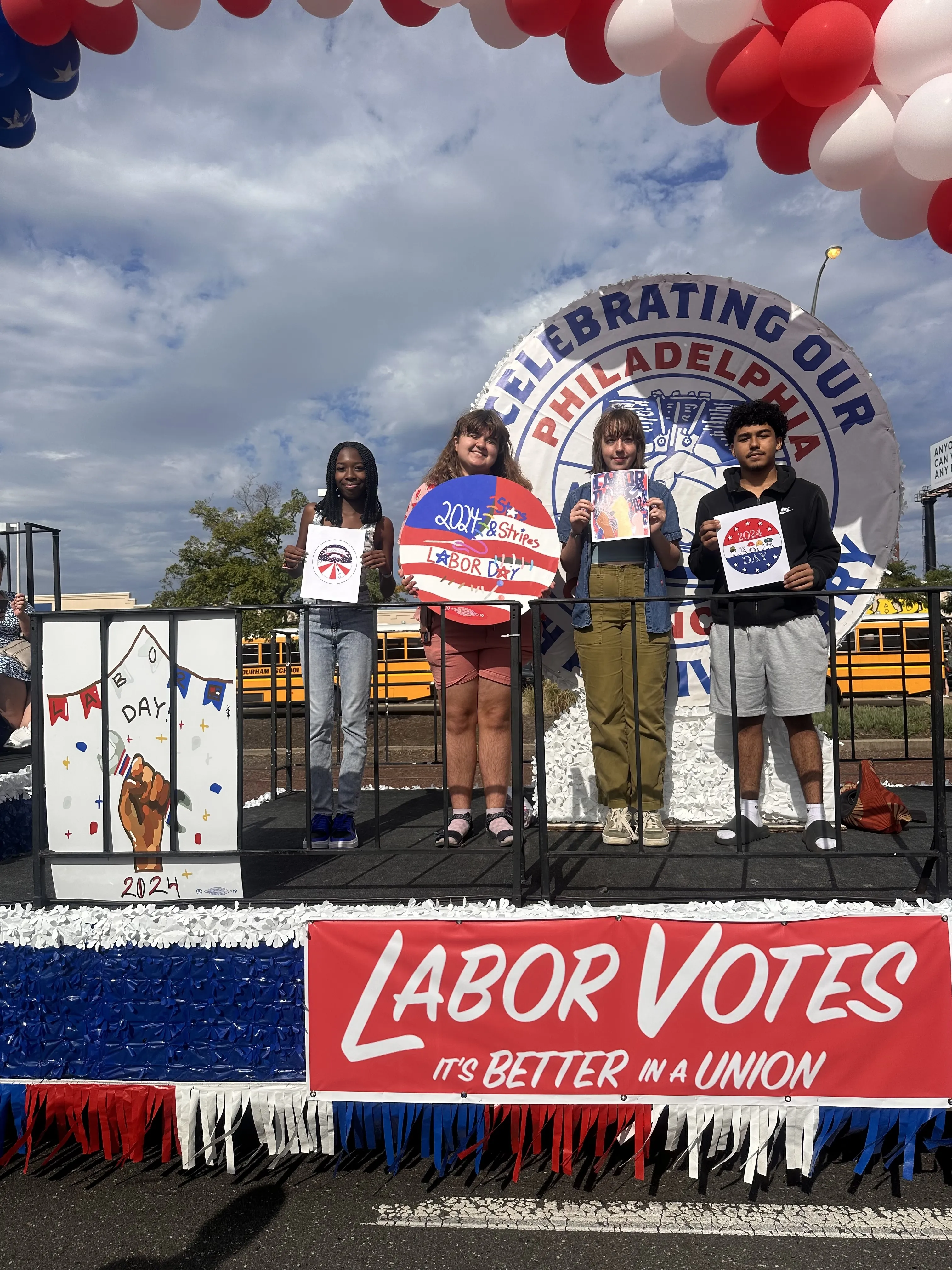 Students on the float with their artwork