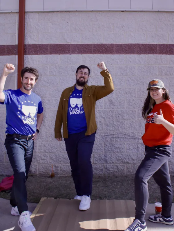 Three union members with fists raised 