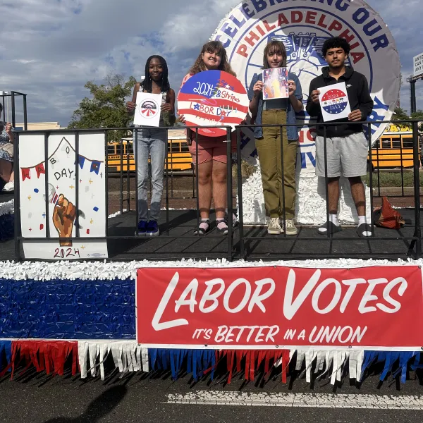 Students on the float with their artwork
