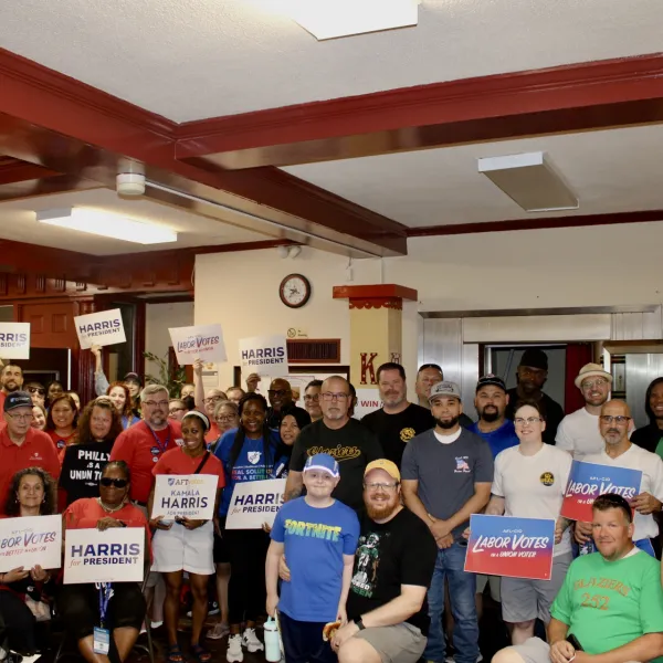 A group of canvassers smile for a photo before going out to knock doors